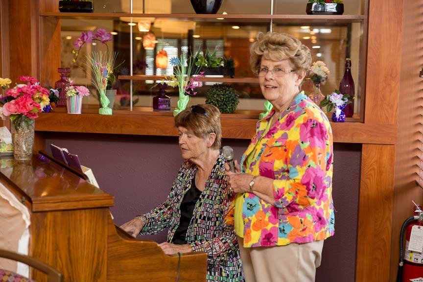 An interior shot of a pianist and vocalist at the Du Quoin Nursing and Rehabilitation Center facility, from the Du Quoin Gallery.